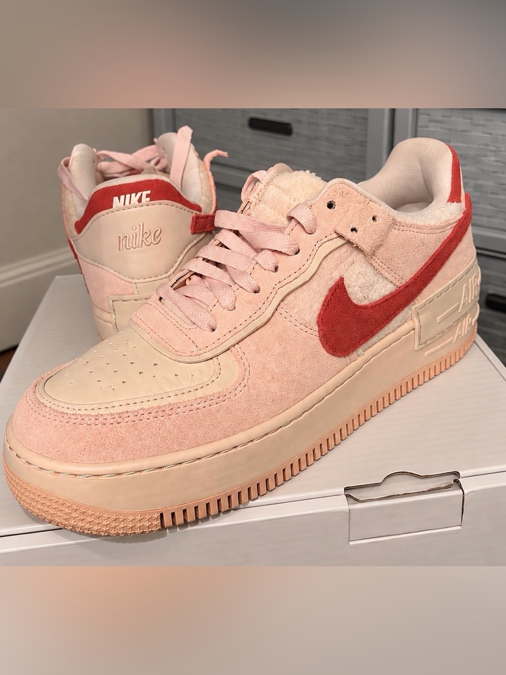 Nike Women’s Pink Suede Low-Top Sneakers with Red Swoosh